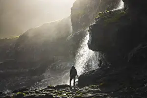 Daylight Prints: A photographer enjoying a beautiful atmosphere on the coast close to Mikladalur