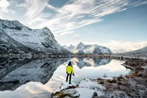 Rorbuer Prints: A photographer observes reflections of mountains in Storvatnet near Vareid