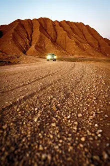 Tracks Prints: Pick-Up traveling at feet of red volcanic mountains, Labyrinth Desert, Puna, Argentina