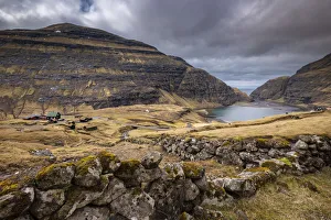 Picturesque Saksun village nestled between mountains on the island of Streymoy, Faroe Islands, Denmark Picturesque Saksun village nestled between mountains on the island of Streymoy, Faroe Islands, Denmark