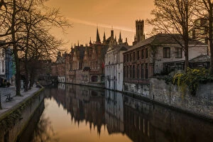 Picturesque sunset view over Dijver canal with Belfort tower in the background, Bruges