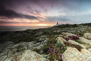Promontory Prints: Pink sky at sunset frames the lighthouse overlooking the Atlantic Ocean Cabo De Sao
