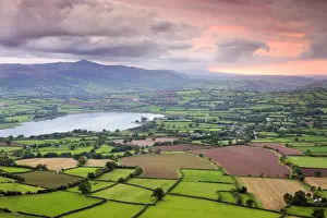 Pink sunset above the Brecon Beacons mountain range and rural countryside near Llangorse