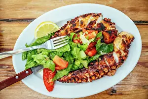 Octopus Prints: Plate of Octopus and salad at Kiki's Tavern restaurant table, Mykonos, Greece, Europe