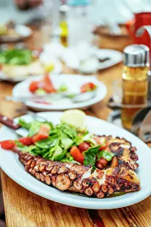 Octopus Prints: Plate of Octopus and salad at Kiki's Tavern restaurant table, Mykonos, Greece, Europe