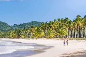 Playa Rincon, Samana Peninsula, Dominican Republic. Couple walking on the beach (MR)