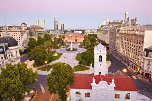 Monserrat Prints: The Plaza de Mayo square at twilight with the Cabildo Museum in foreground and the Casa Rosada in background
