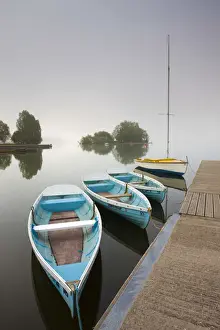 Pleasure boats moored at Llangorse Lake on a misty morning, Brecon Beacons National Park