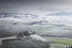 Rolling Hills Prints: Podere Belvedere covered in snow during a rare winter blizzard in Val d Orcia