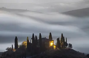 Podere Belvedere and mist-filled Val d'Orcia at dawn, San Quirico d'Orcia, Tuscany, Italy
