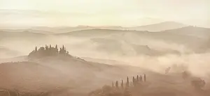 Podere Belvedere and mist-filled Val d'Orcia at dawn, San Quirico d'Orcia, Tuscany, Italy