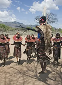 Beaded Necklaces Prints: A Pokot warrior wearing a cheetah skin jumps high in the air surrounded by young women to celebrate an Atelo ceremony