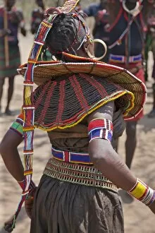 Images Dated 28th December 2010: A Pokot woman in traditional attire dances to celebrate an Atelo ceremony