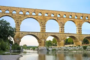 Pont du Gard Roman aqueduct over Gard River at sunset, Gard Department
