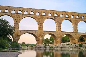 Pont du Gard Roman aqueduct over Gard River at sunset, Gard Department