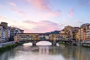 Ponte Vecchio on the Arno river and buildings in the old town at sunrise, Florence