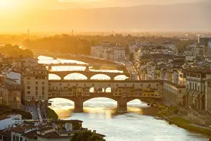 Backlight Prints: Ponte Vecchio on the Arno river and buildings in the old town at sunset, Florence