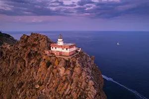 Tyrrhenian Prints: The Ponza's lighthouse on top of a volcanic cliff and surrounded by the sea at dusk