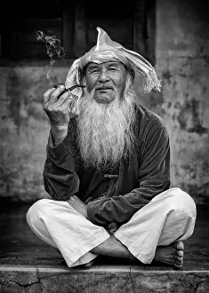 B And W Prints: Portrait of an old man wearing conical hat and smoking a pipe