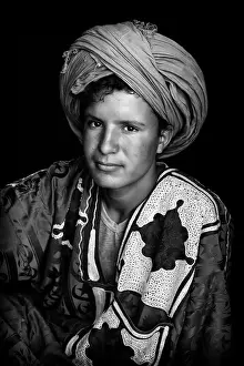 Wearing Prints: Portrait of a young Berber man wearing traditional headscarf (Cheche), Merzouga, Morocco