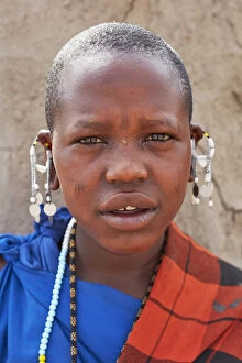 Portrait of a young Maasai girl with a traditional Shuka dress in a village near Arusha, Tanzania, Africa
