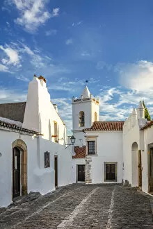 Images Dated 10th September 2020: Portugal, Alentejo, Monsaraz. Cobbled streets leading to the bell tower gateway of the