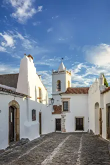 Hamlet Prints: Portugal, Alentejo, Monsaraz. Cobbled streets leading to the bell tower gateway of