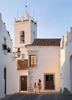 Portugal, Alentejo, Monsaraz, Woman and girl walking down cobbled street (MR)