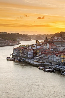 Portugal, Douro Litoral, Porto. Sunset over the UNESCO listed Ribeira district, viewed