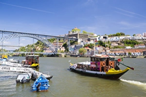 Portugal, Douro Litoral, Porto. Tourists boats on Douro River in the UNESCO listed