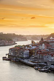 Portugal, Douro Litoral, Porto. Sunset over the UNESCO listed Ribeira district, viewed