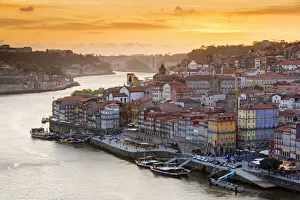 Portugal, Douro Litoral, Porto. Sunset over the UNESCO listed Ribeira district, viewed