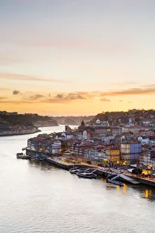 Portugal, Douro Litoral, Porto. Sunset over the UNESCO listed Ribeira district, viewed