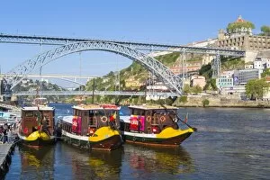 Portugal, Douro Litoral, Porto. Tourists boats on Douro River in the UNESCO listed