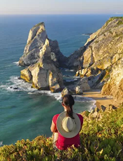 Images Dated 8th May 2014: Portugal, Estramadura, Ursa woman sitting on cliff edge (MR)