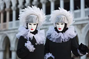 St Marks Square Gallery: Two poseurs dressed as identical twins pose in St Marks Square during the Venice