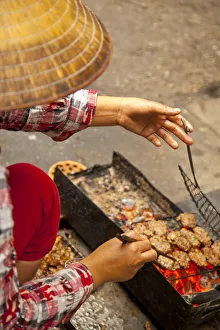 Preparing grilled pork as part of Bun Cha Street food, Old Quarter, Hanoi, Vietnam