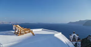Private beach chairs on the coastline of Oia, Santorini, Cyclades Islands, Greece