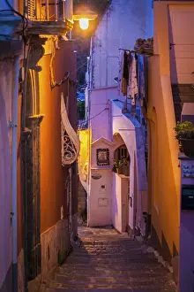 Procida Prints: Procida island, Naples, Italy. A narrow street illuminated at dusk