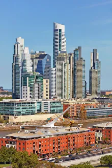 Images Dated 27th April 2023: The 'Puente de la Mujer' bridge with the skyscrapers of Puerto Madero in the background