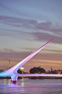 The 'Puente de la Mujer' bridge with a special illumination at twilight, Puerto Madero, Buenos Aires, Argentina Images Dated 27th April 2023: The 'Puente de la Mujer' bridge with a special illumination at twilight, Puerto Madero, Buenos Aires