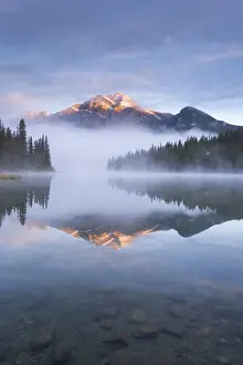 September Prints: Pyramid Mountain in the Canadian Rockies surrounded by mist and reflected in Pyramid Lake