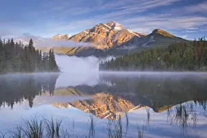 Rocky Mountains Prints: Pyramid Mountain reflected in Pyramid Lake at dawn on a misty morning