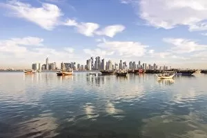 Images Dated 24th March 2014: Qatar, Doha. Cityscape with fishing boats in the foreground