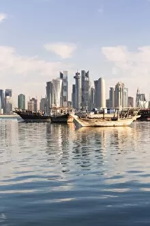 Images Dated 24th March 2014: Qatar, Doha. Cityscape with fishing boats in the foreground