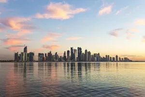 Images Dated 24th June 2014: Qatar, Doha. Cityscape at sunrise from the Corniche