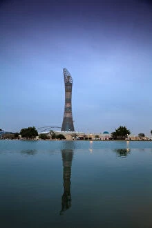 Qatar, Doha, The Torch Hotel reflecting in the lake in Aspire Park