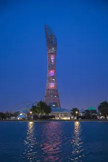 Qatar, Doha, The Torch Hotel reflecting in the lake in Aspire Park