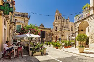 Ragusa Ibla, Sicily. Tourists walking and sitting in the restaurants in the main square
