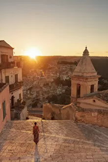 Images Dated 17th September 2020: Ragusa Ibla, Sicily. A woman walking on the stairs with Ragusa old town in the background
